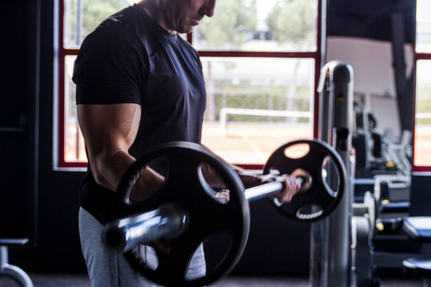 istock Middle Aged Bodybuilder Puffing Her Muscles In The Gym 1499537134