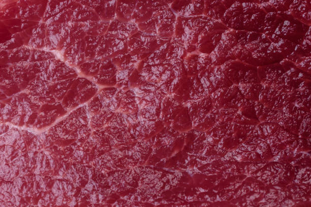 istock Juicy raw beef with spices, salt and herbs on a dark concrete background 1499545205