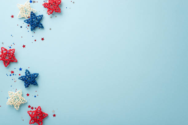 istock Create enchanting ambiance for your Independence Day celebration with symbolic party elements: top view of rattan stars and sparkle confetti. Pastel blue backdrop includes empty space for text or ad 1499545311
