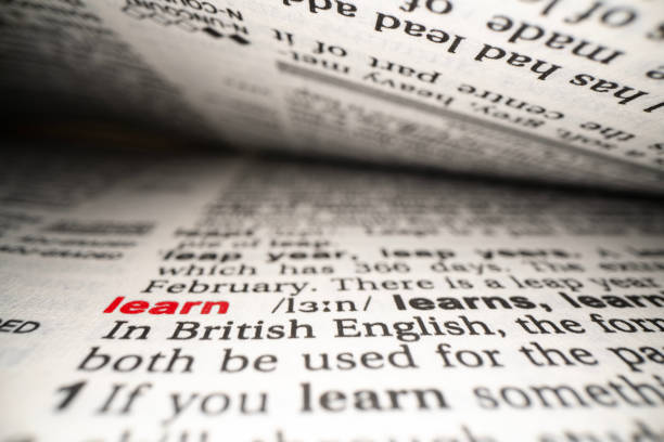 istock Closeup of English dictionary page with word Learn. 1499545609