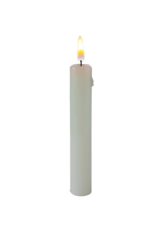 Burning candle made of white paraffin wax isolated on white. Bright flame.