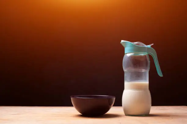 bottle with milk for morning breakfast on wooden table. High quality photo