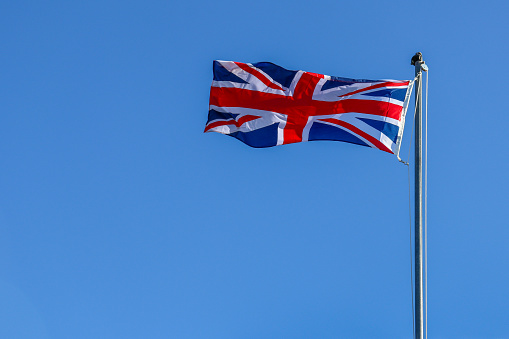 Union Jack British flag against blue sky