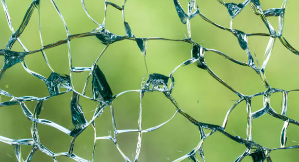 istock cracked glass. broken glass background or texture 1499553249
