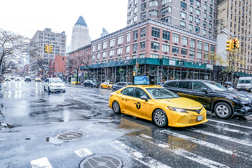 Rainy overcast day in Manhattan New York city. Wet streets. Taxi. Photographed on 12/18/21