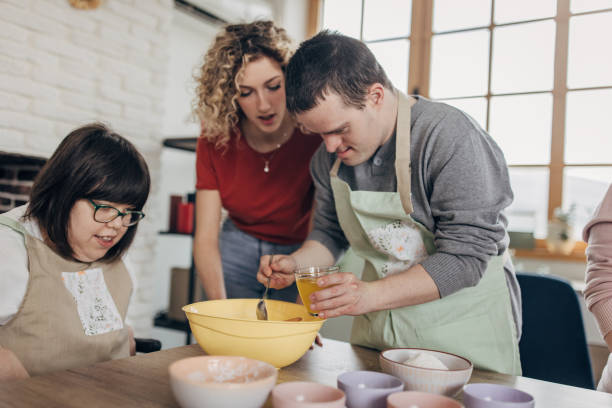 People with down syndrome on cooking class stock photo