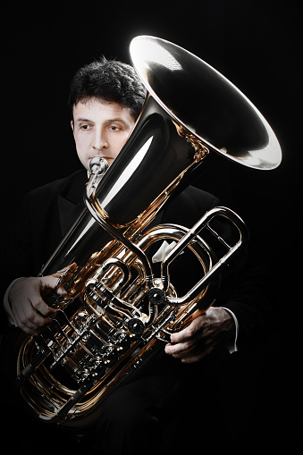 Tuba brass instrument. Classical musician  horn player tuba playing. Bass orchestra instrument euphonium Tubist