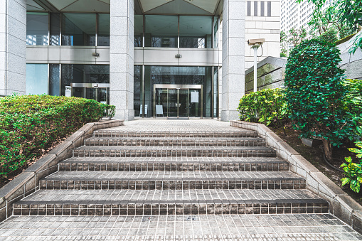 Stone staircase leading to office buildings.