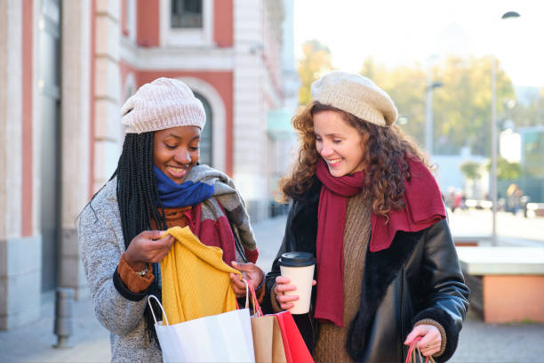 istock Two multiracial female friends looking the clothes they bought. 1499580093