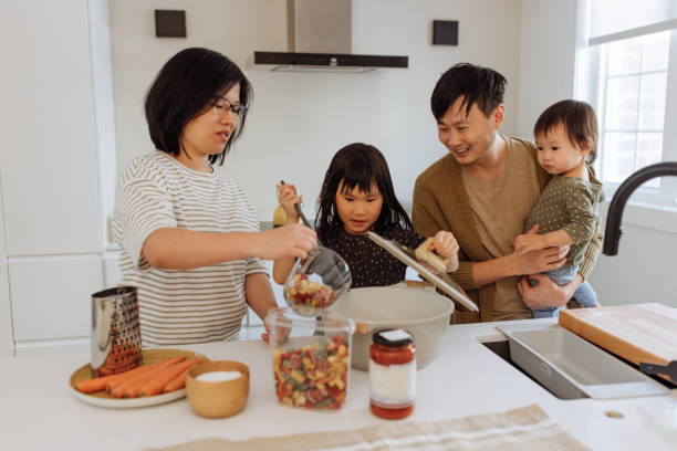 istock Asian parents and two kids in the kitchen 1499582102