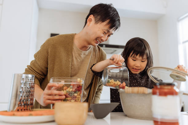 istock Dad and daughter cooking in the kitchen 1499582108
