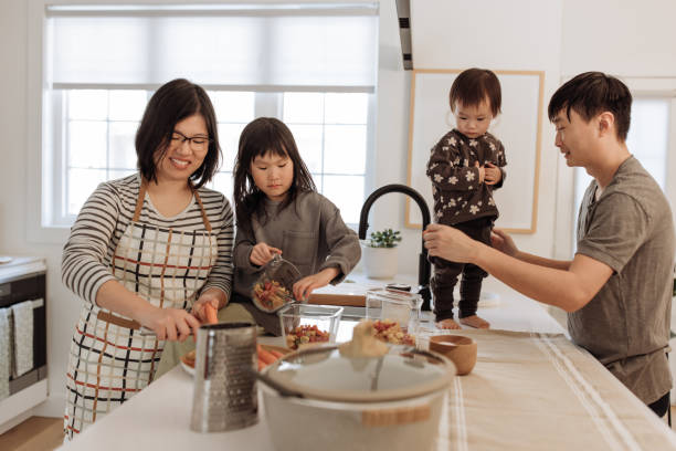 istock Asian parents and two kids in the kitchen 1499582149