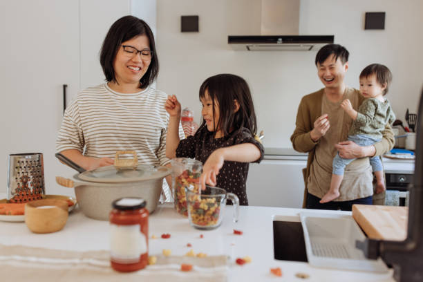 Asian parents and two kids in the kitchen