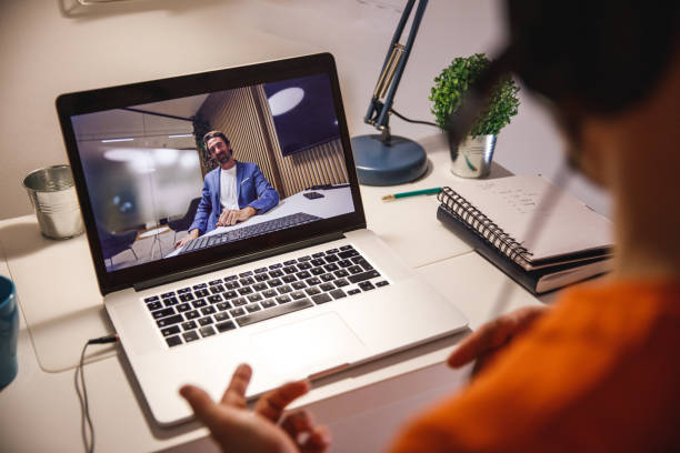 istock Young man video chatting with a friend late at night 1499582291