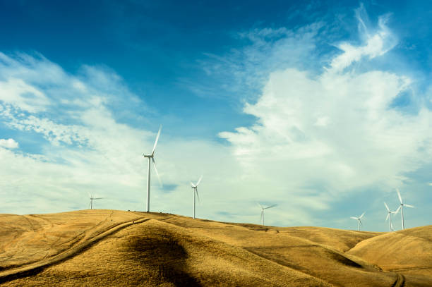 istock Wind Turbines On Hill With Clouds in Background 1499583091
