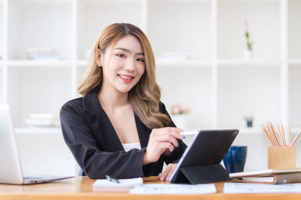istock Charming millennial female manager using digital tablet at her workstation. 1499587575