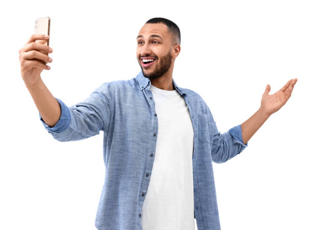 istock Smiling young man taking selfie with smartphone on white background 1499592533
