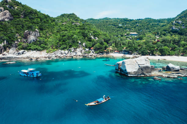 istock tropical island and long-tail boat 1499617974