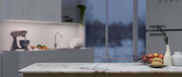 istock Close-up image of a copy space on a white marble kitchen countertop in a modern white kitchen 1499623616