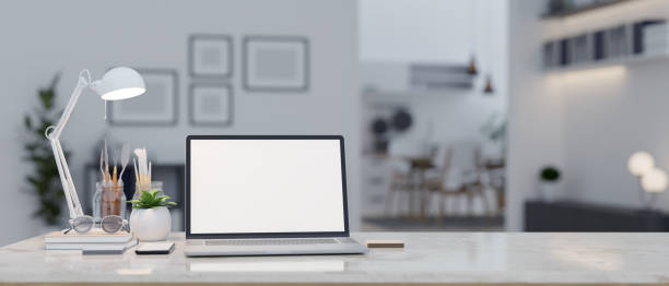 istock A laptop mockup on a table in a modern contemporary living room. close-up workspace. 1499623637