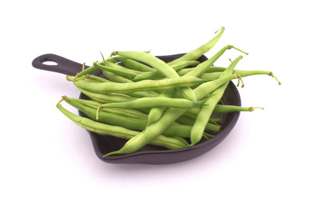 istock Green beans in the cooking pan isolated on white 1499628511