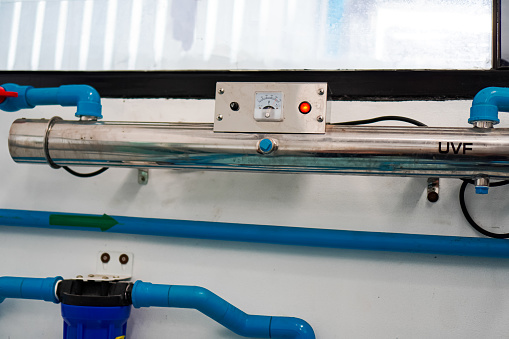 The picture shows a set of UV filter equipment used as the final step in making reverse osmosis drinking water.