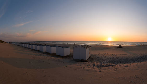 istock On the coast with beach huts whit the sun go down 1499637737