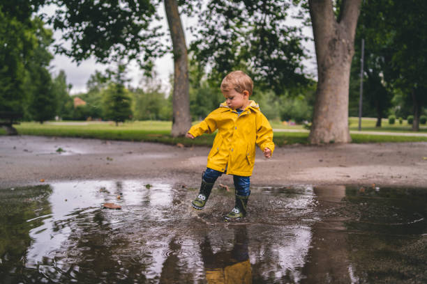 istock Adorable little boy playing at rainy day 1499638150
