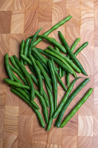 Close-up of green beans, detailed. Healthy food fresh cooking. Close up top view. Raw green beans. Wooden background.