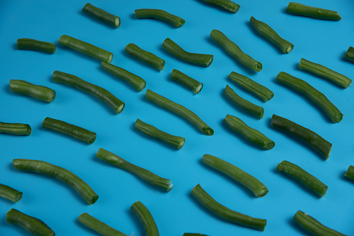 Close-up of green beans, detailed. Healthy food fresh cooking. Close up top view. Raw green beans. Blue colorful  background.