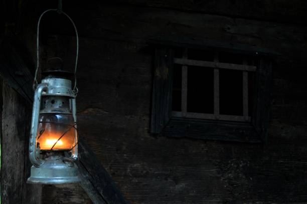 istock lit lantern on an old wooden house 1499639361