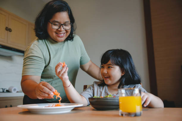 istock Indonesian Daughter Making Green Salad With Her Mother 1499640948