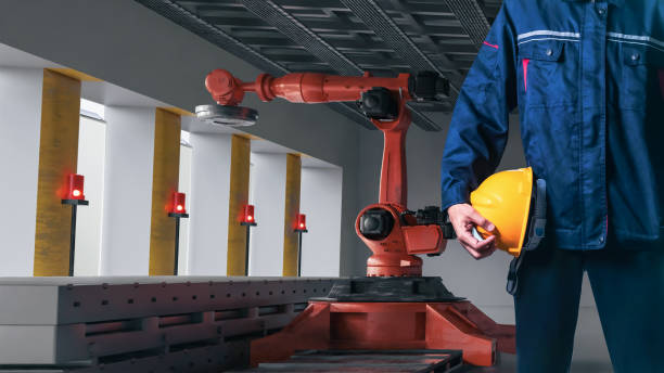 istock Asian Man Engineer hold smartphone touch touching UI screen interface for manufacturing industry technology Product export and import future Robot cyber warehouse arm robot future technology 1499645238