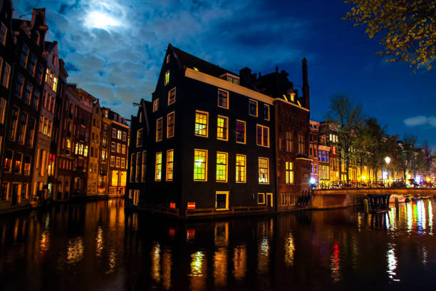 istock Amsterdam illuminated old house architecture at night, Netherlands 1499648675