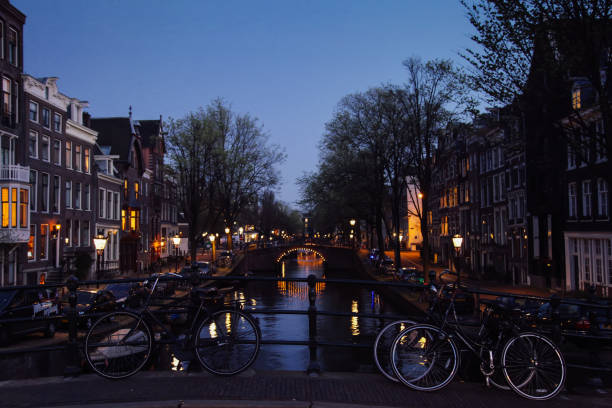 istock Amsterdam canal bridges bicycles at night, Netherlands 1499648780