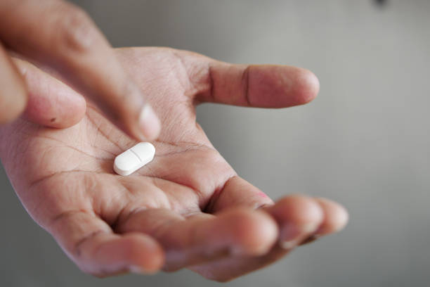 istock Close up of man hand holding pills with copy space 1499649651