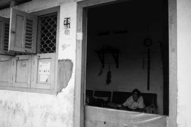 An old woman sitting indoors in the village of Sudiroprajan, Surakarta, Indonesia