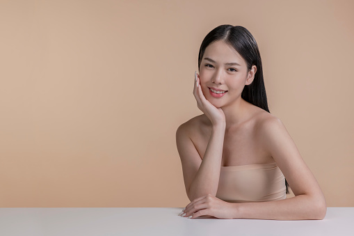 Portrait of a young Asian woman with natural makeup and natural styling. Advertising natural cosmetics. Advertising for a beauty salon. Care cosmetics, face and body skin care.