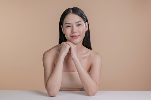Portrait of a young Asian woman with natural makeup and natural styling. Advertising natural cosmetics. Advertising for a beauty salon. Care cosmetics, face and body skin care.