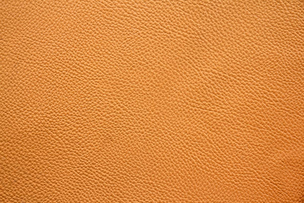istock Orange or brown background of leather sheet texture 1499651058