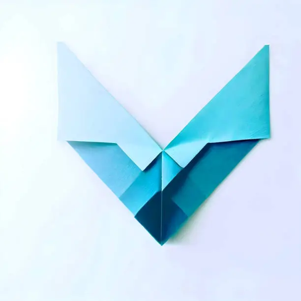 Combines the concept of a checkmark with the elegance of origami. The logo features a folded paper-like shape forming a stylized checkmark, symbolizing approval, completion, and satisfaction.