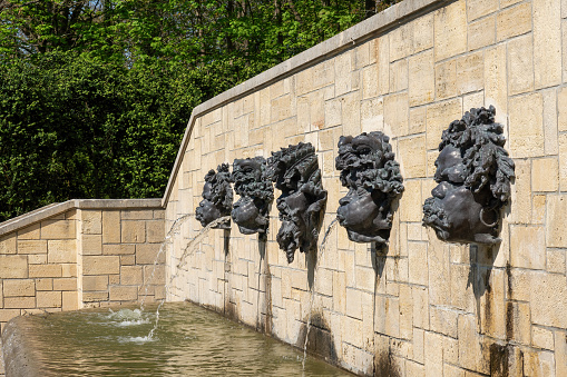 Water flowing out from Rodin's Mascarons in public Departemental Parc de Sceaux (Auguste Rodin - 1840-1917) - Hauts-de-Seine, France.