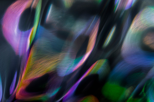 Abstract vibrant colored pattern. Polarized light view through glass structure. Dynamic multicolored artistic background.