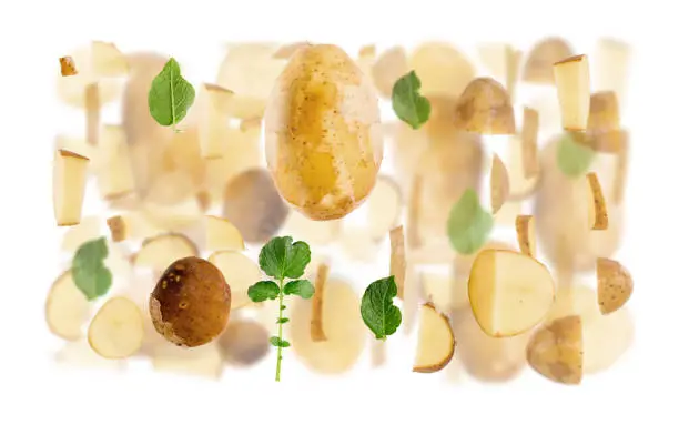 Abstract background made of Potato fruit pieces, slices and leaves isolated on white.