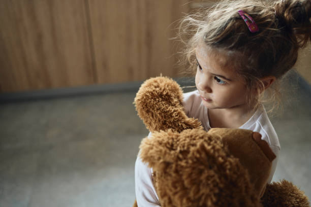 istock Small girl with chickenpox hugging her teddy bear 1499658504