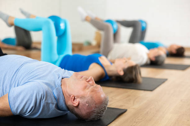 istock Elderly man practicing pilates with ball in gym area 1499659259