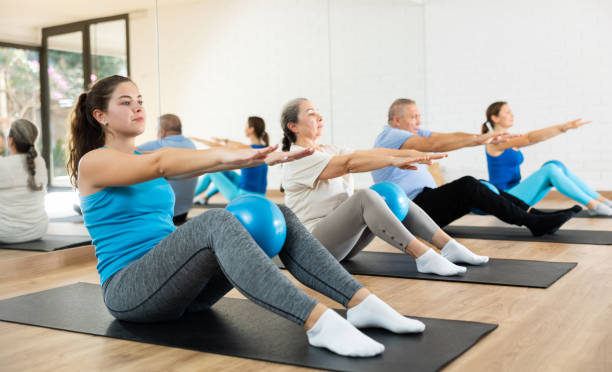 istock Young woman practicing pilates with ball in gym area 1499659263