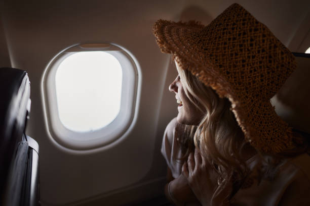istock Happy woman enjoying while traveling by plane. 1499659490