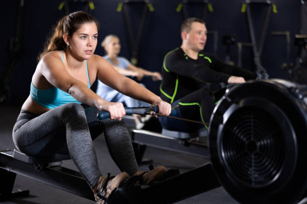 istock Sporty young woman using cable row machine in gym 1499660160