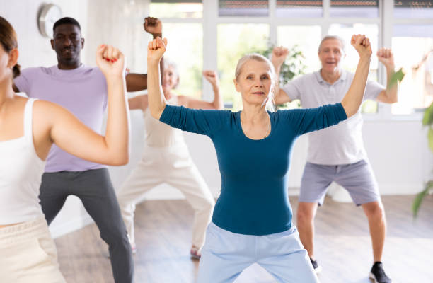 istock Elderly woman dancing hip hop during group dance class 1499661658